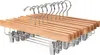 A set of wooden hangers with metal clips on a white background. Produktbild-Vorschau