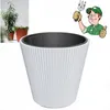 A white ribbed planter with a dark gray inner pot, shown next to a smaller image of two potted plants and a cartoon gardener giving a thumbs up. Produktbild-Vorschau