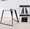 Two black metal table legs are shown on a light wood floor. Inset images highlight mounting holes and protective felt pads. Náhled obrázku produktu
