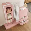 A pink wardrobe set with clothes hanging on a rack and items in shelves and drawers. Anteprima dell’immagine prodotto