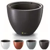 A large dark gray planter pot is shown from the front, with smaller versions of the same pot in white, copper, gray, and dark gray displayed below it. Produktbild-Vorschau