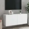 A white TV cabinet mounted on a gray wall, with a TV on top and some decorative items. Produktbild-Vorschau