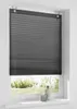 A dark grey pleated blind is shown in a white window frame, with a garden visible through the bottom part of the window. Produktbild-Vorschau