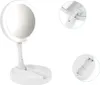 A white makeup mirror with LED lights is shown on a white background. The mirror is in an upright position, with its base open, revealing a tray. Close-up insets show the hinge mechanism and the battery compartment. Náhľad obrázku produktu