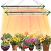 Two grow lights are shown suspended above a collection of potted plants, with light beams emanating from the lights onto the plants. Produktbild-Vorschau