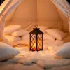 A cozy indoor tent setup with pillows, a lantern, and fairy lights. Produktbild-Vorschau