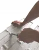 Hands cutting a white 3D PVC wall panel with a knife. Produktbild-Vorschau