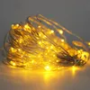 A close-up of a coiled string of warm white LED lights with a copper wire. Produktbild-Vorschau
