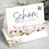 A folded greeting card with a floral and butterfly design. Produktbild-Vorschau