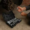 A person is using a socket wrench set to work on a car's brake rotor. Anteprima dell’immagine prodotto