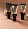 Three tubes of Mizon Snail Repair Intensive BB Cream are displayed on a light brown surface, with swatches of the product on the surface in front of two of the tubes. Podgląd zdjęcia produktu