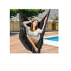 A woman relaxing in a black hammock chair by a swimming pool. Produktbild-Vorschau