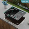 A black kitchen sink with dimensions labeled, installed on a countertop. Produktbild-Vorschau