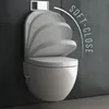 A modern wall-mounted toilet with a soft-close lid, shown in a bathroom setting with a dark gray tiled wall. Produktbild-Vorschau