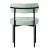A light green upholstered chair with black metal legs, shown from the back. Náhled obrázku produktu