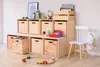 A wooden shelving unit filled with toys and books, with a small white chair next to it. Voir les images du produit
