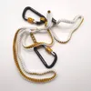 Two black carabiners attached to a white and gold bungee cord. Náhľad obrázku produktu