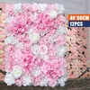 A wall covered in artificial pink and white flowers, with a product label in the corner. Voir les images du produit