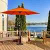 An orange patio umbrella is set up on a wooden deck overlooking a body of water. Voir les images du produit