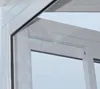 Close-up view of the corner of a white aluminum structure, possibly a greenhouse or sunroom, showing the frame and a section of glass. Podgląd zdjęcia produktu