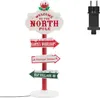 A Christmas-themed directional signpost with multiple signs pointing to different locations. Podgląd zdjęcia produktu