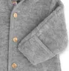 A close-up view of a grey baby overall, showing wooden buttons and the fabric texture. Produktbild-Vorschau