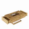 A modern coffee table with a wood finish, a glass insert, and two open drawers, shown against a white background. Produktbild-Vorschau