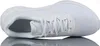 A white Nike shoe is shown from the side, with its reflection visible below. Voir les images du produit