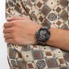 A man's arm wearing a Tommy Hilfiger watch, with his arm crossed over his chest. Náhľad obrázku produktu