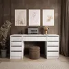 A modern home office setup with a white desk, laptop, lamp, and artwork on the wall. Produktbild-Vorschau