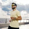 A man is running outdoors near a body of water, wearing a smartwatch. Náhled obrázku produktu