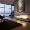 A modern living room with a large window overlooking a body of water, featuring a sleek fireplace with flames. Produktbild-Vorschau