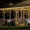 Christmas lights and decorations on a porch at night. Náhled obrázku produktu