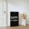 A black shoe cabinet is shown in a hallway next to a white door. Podgląd zdjęcia produktu