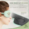 A woman wearing a turquoise sleep mask, with a close-up view of the mask's interior showing its 3D design. Anteprima dell’immagine prodotto
