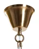 Close-up of the top part of a chandelier, showing the brass-colored metal ceiling mount and a clear acrylic glass element. Náhled obrázku produktu