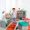 A young boy stands in a room decorated with Minecraft-themed storage boxes and furniture. Produktbild-Vorschau