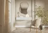 A modern entryway or dressing area with a console table, mirror, chair, and plant. Voir les images du produit