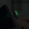 A close-up shot of a black USB-C charging cable with a 90-degree angle connector plugged into a smartphone. The connector has a green LED light indicating charging. Anteprima dell’immagine prodotto
