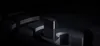 A black electronic device is displayed on a dark, abstract platform with dramatic lighting. Náhľad obrázku produktu