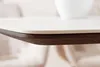 Close-up of a table edge with a white top and a dark wood edge. Produktbild-Vorschau