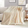 A plush blanket draped over a sofa in a living room setting. Produktbild-Vorschau