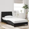 A black bed frame with a white mattress and pillow in a room with a window. Podgląd zdjęcia produktu