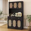 A black kitchen cabinet with rattan accents, featuring a microwave and various jars on top, placed in a dining room setting. Podgląd zdjęcia produktu