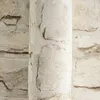 A close-up view of textured wallpaper with a stone pattern. Produktbild-Vorschau