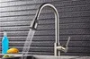 A kitchen faucet with water running, in front of a textured backsplash. Náhľad obrázku produktu