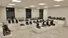 A showroom displaying various commercial kitchen appliances, including waffle makers and chocolate warmers, arranged on white display stands. Anteprima dell’immagine prodotto
