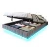 A bed with its storage compartment open, showing folded linens and blankets inside. The bed frame has integrated LED lighting. Náhľad obrázku produktu