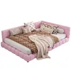 A pink corner daybed with several decorative pillows and a throw blanket. Podgląd zdjęcia produktu