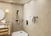 A modern bathroom with a shower, sink, and vanity. Anteprima dell’immagine prodotto